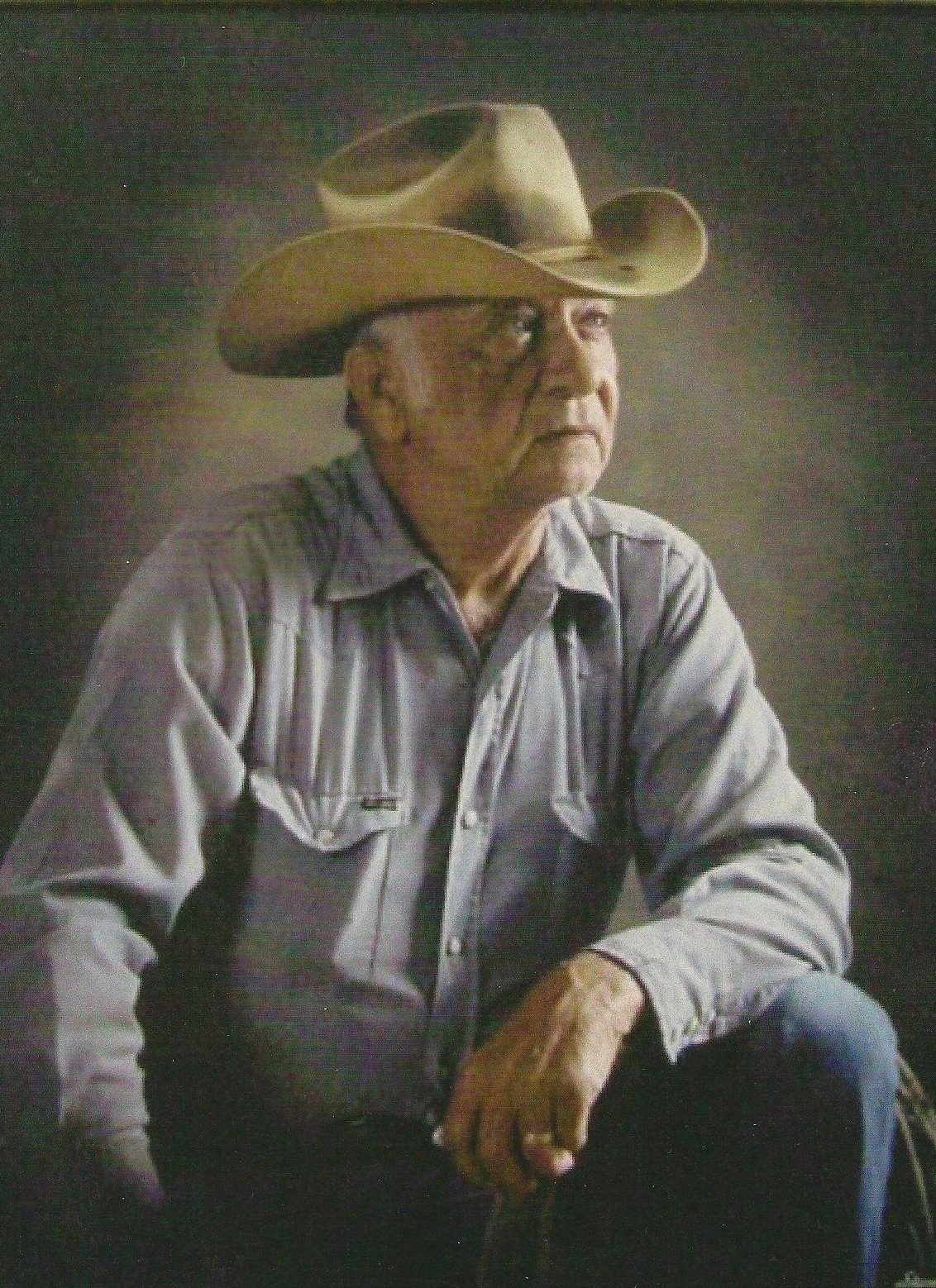 A portrait photo of a main in a cowboy hat