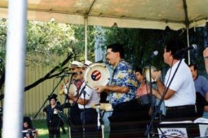 Puerto Rican musical band plays on a stage.