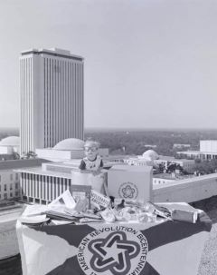 Child with Bicentennial paraphernalia on rooftop across from Capitol.
