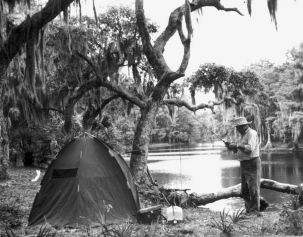 A fisherman makes ready for fishing from the bank of Fisheating Creek - Glades County, Florida.